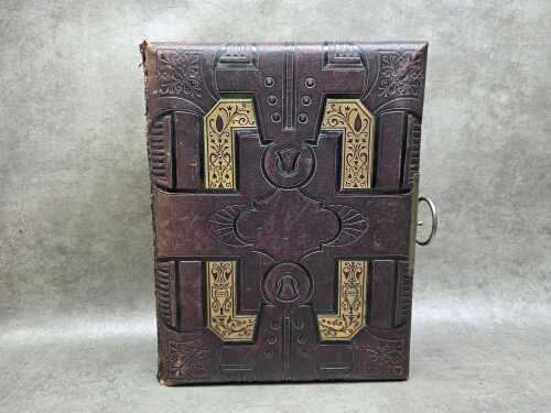 Antique leather-bound photo album with a brass clasp