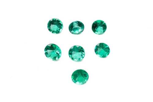 A collection of seven round emeralds