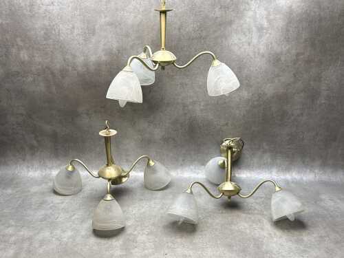 Three brass pendant lights with frosted glass shades