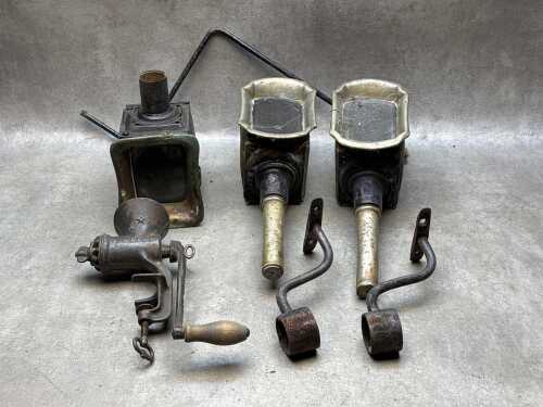 Three antique carriage lamps and brackets with an antique meat grinder