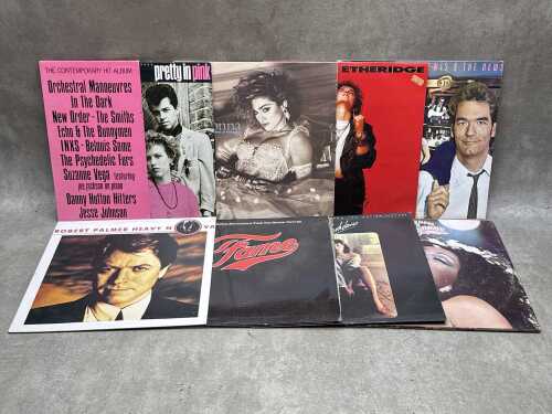 Eight vinyl records, including '80s, soundtracks, and disco