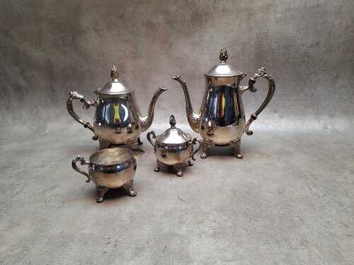 Silver-plated tea service including teapot, hot water pot, sugar bowl and creamer