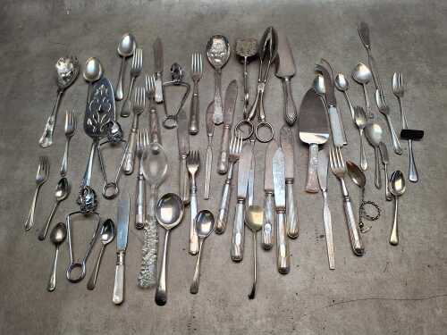 Assorted cutlery including silver-plated 'berry' pattern salad servers, serving tongs,