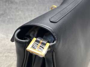 Designer-style black leather handbag with gold-tone hardware. - 4