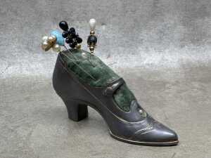 Two cast metal shoes, including a pin cushion with hat pins - 2