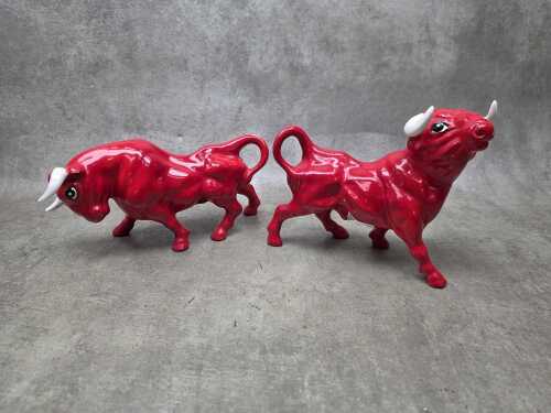 Two mid-century red glazed porcelain bull figures