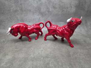 Two mid-century red glazed porcelain bull figures