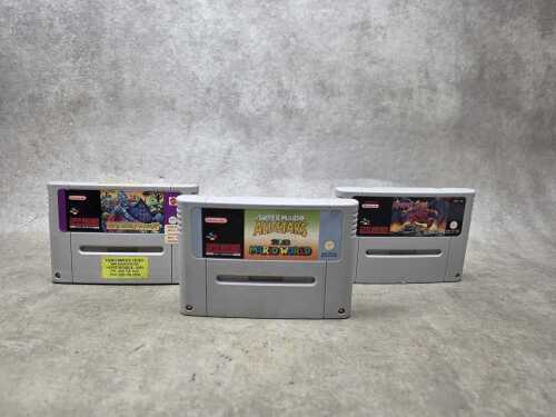 Three Super Nintendo game cartridges