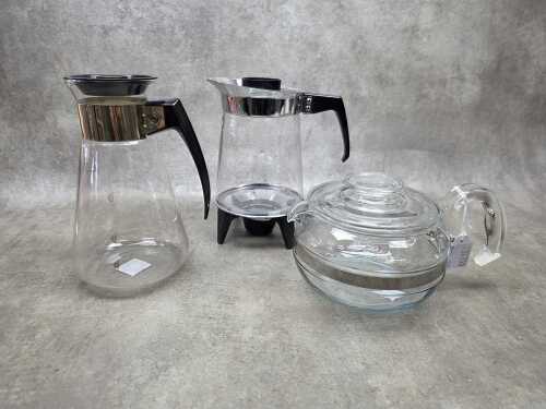 Three retro glass coffee pots including Pyrex, J&J on warming stand, etc.
