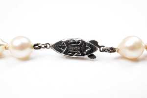 A strand of semi baroque pearls to a silver clasp - 5