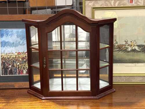 Mahogany wall-mounted display cabinet with arched top and glazed doors