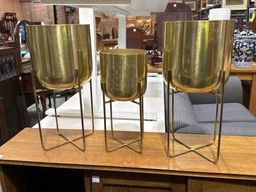 Three gold-tone metal planters on stands