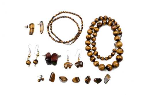 A collection of tigers eye jewellery and stones