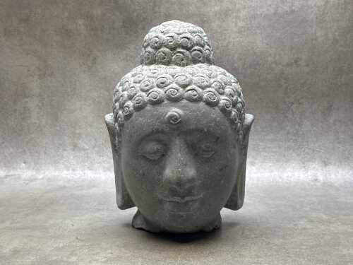 Sculptured grey stone Buddha head