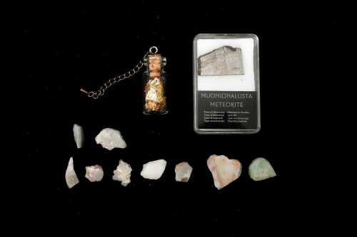 A group of precious stones including a meteorite piece, gold leaf and opal