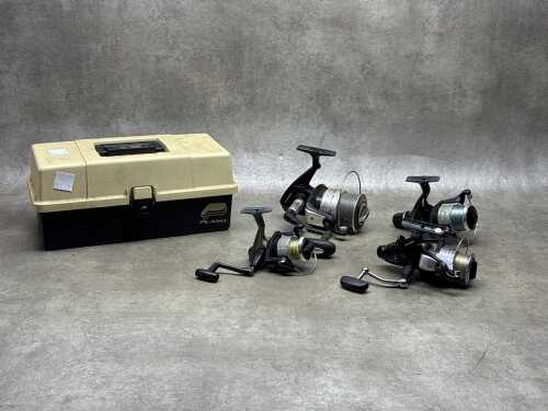 Four fishing reels and a tackle box