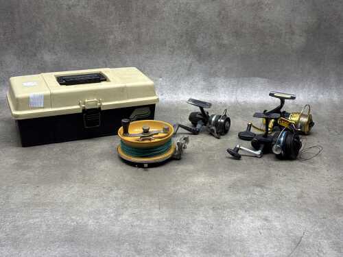 Four fishing reels and a tackle box