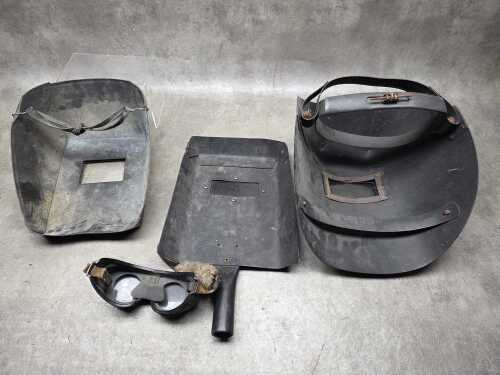 Three welding helmets and googles