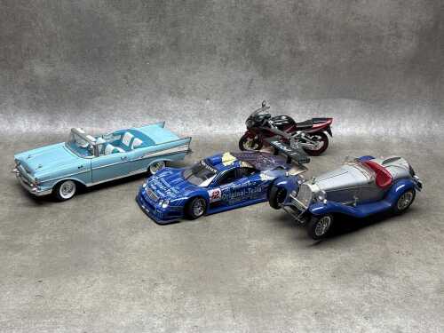 Four model vehicles including an Ertl '57 Chevrolet Bel Air, a Maisto Mercedes CLK-GTR, etc
