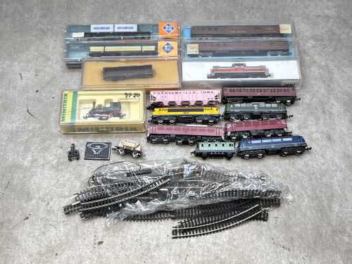 Group of model train N-gauge passenger carriages and freight cars