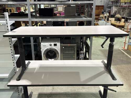Grey height-adjustable office desk on column legs