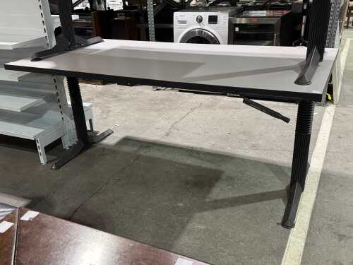 Grey height-adjustable office desk on column legs