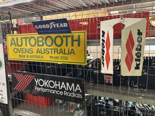 Four metal automotive advertising signs