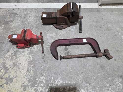 Two cast iron bench vices and a C clamp