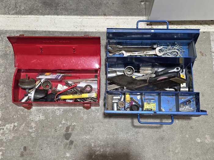 Two metal toolboxes with various tools