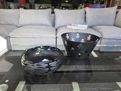 Two Alessi black decorative metal bowls