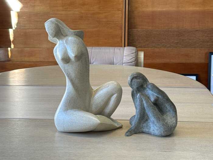 Two abstract resin female figures in grey and oatmeal