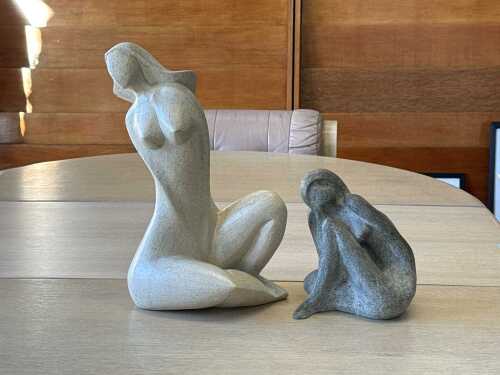 Two abstract resin female figures in grey and oatmeal