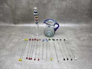Hand-blown glass swizzle sticks together with a Galileo thermometer