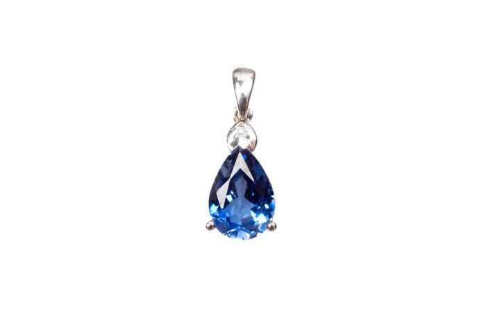 A synthetic sapphire and natural diamond pendant in 9 carat white gold
