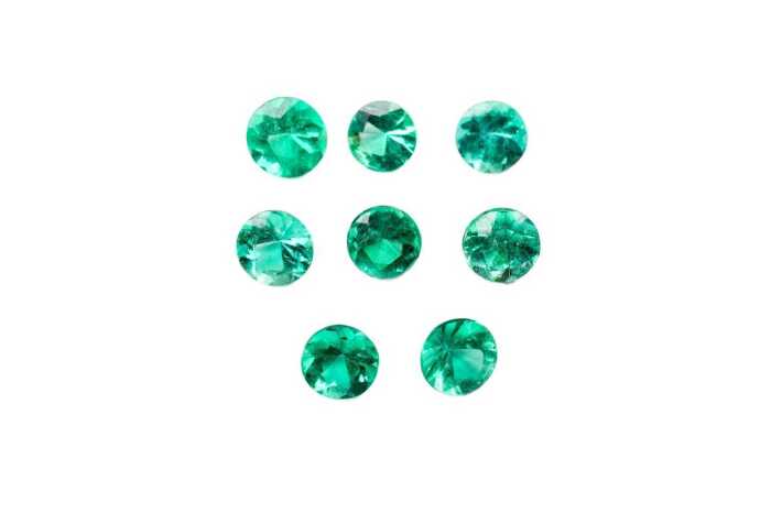 A collection of eight round natural emeralds