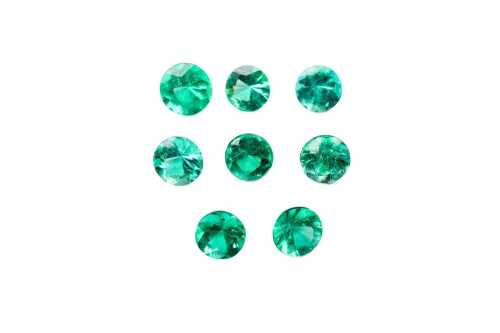 A collection of eight round natural emeralds