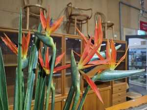 Terracotta ribbed vase displaying vibrant artificial Birds of Paradise blooms - 3