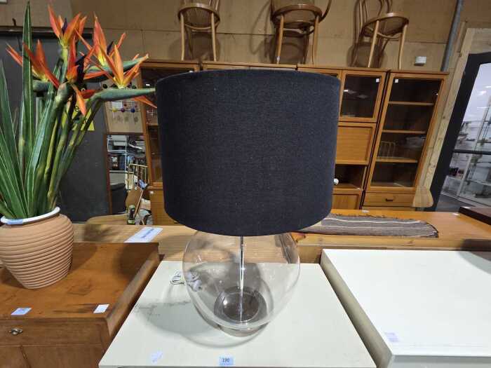 Large clear glass rounded table lamp with black fabric shade