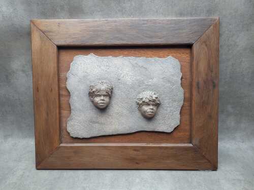 Resin wall plaque in the style of William Ricketts
