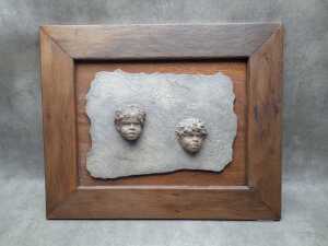 Resin wall plaque in the style of William Ricketts