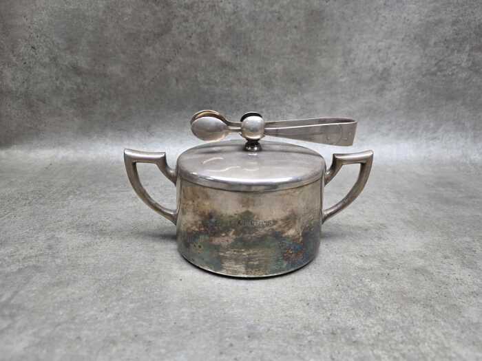 German Art Deco silver plated sugar bowl with attached sugar tongs,