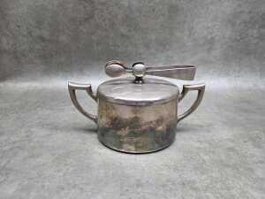 German Art Deco silver plated sugar bowl with attached sugar tongs,
