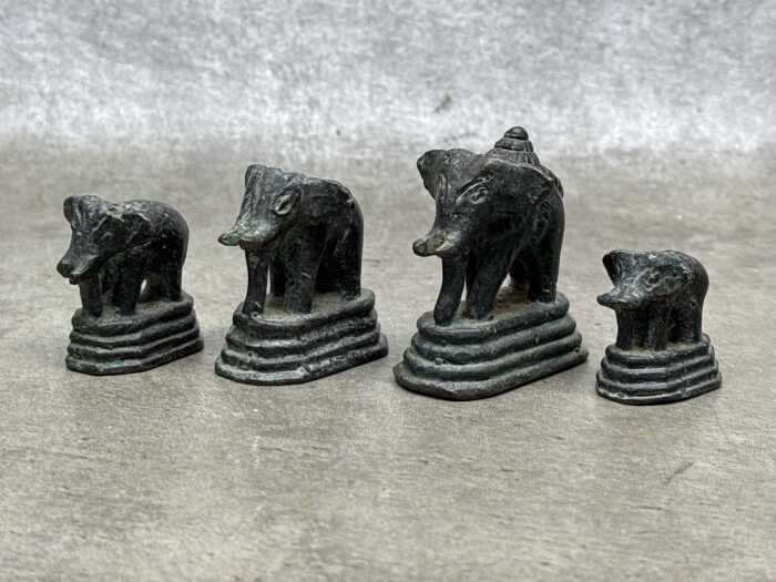 Antique Burmese set of four brass opium weights surmounted by elephant figures