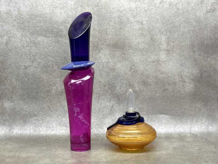 Two perfume glass and plastic store display bottles