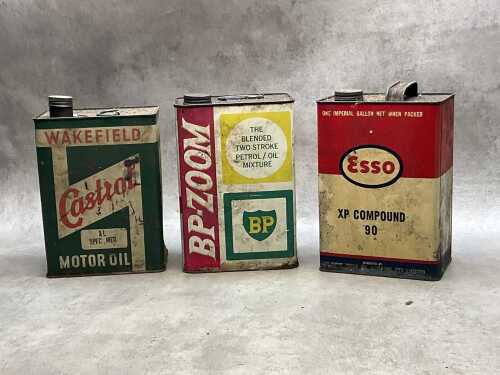 Three oil tin cans, including Esso
