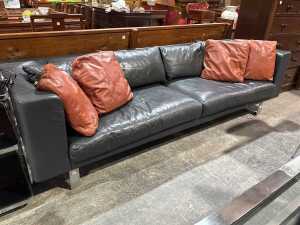 Black leather three-seat sofa on chrome base