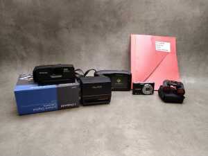 Three Polaroid cameras and one Panasonic digital camera