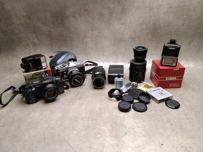 Two Canon SLRs with lenses and accessories
