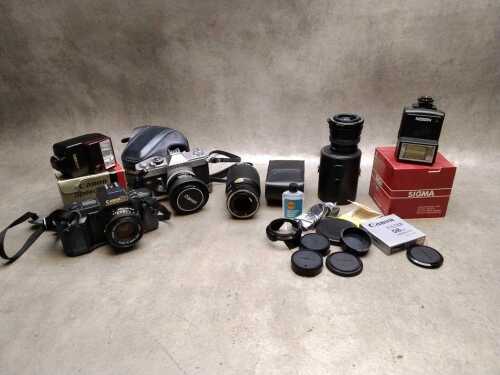 Two Canon SLRs with lenses and accessories