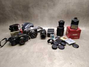 Two Canon SLRs with lenses and accessories